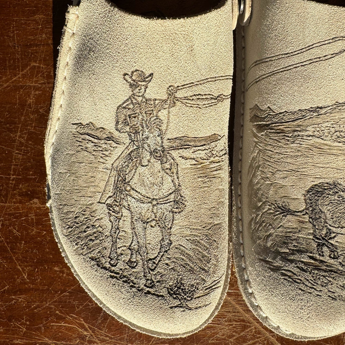 cowboy roping bull on eggshell lutry (suede leather)
