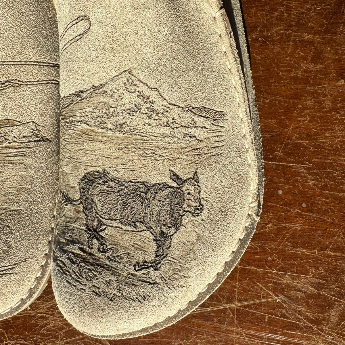 cowboy roping bull on eggshell lutry (suede leather)